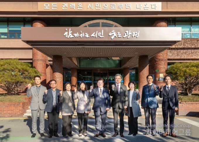 박승원 광명시장(사진 가운데)이 정순욱 부시장(사진 오른쪽 네 번째), 실국장들과 '모든 권력은 시민으로부터 나온다'는 문구가 새겨진 시청 본관 앞에서 기념사진을 촬영하고 있다.