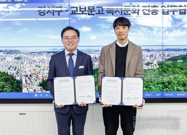 진교훈 서울 강서구청장(왼쪽)이 구청에서 박용식 교보문고 원그로브점장과 ‘독서문화 진흥 업무협약’을 체결하고 기념촬영을 하고 있다.